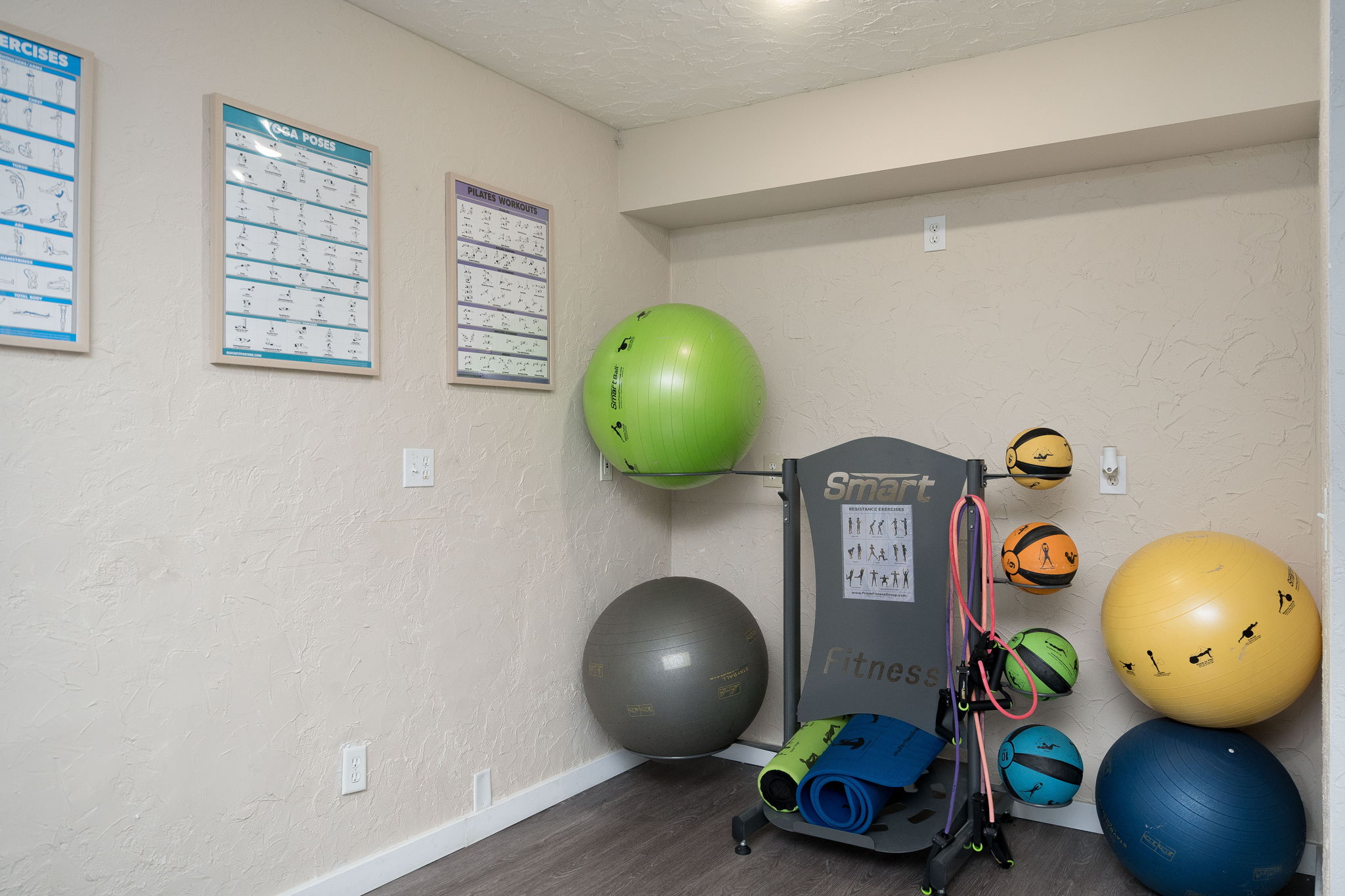 A room with exercise equipment and a wall calendar.